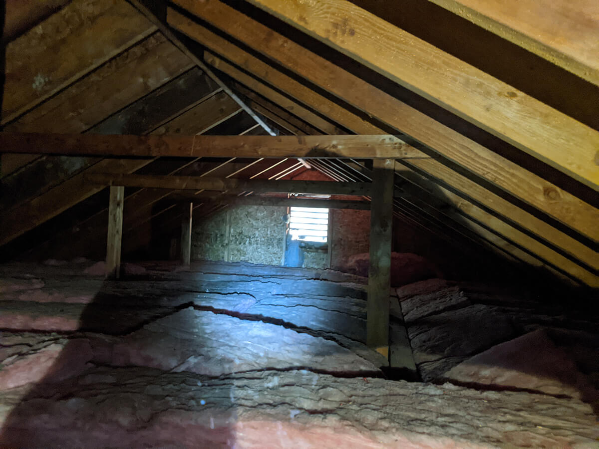 The right of the attic is open rafters with insulation between as well as a gable vent.